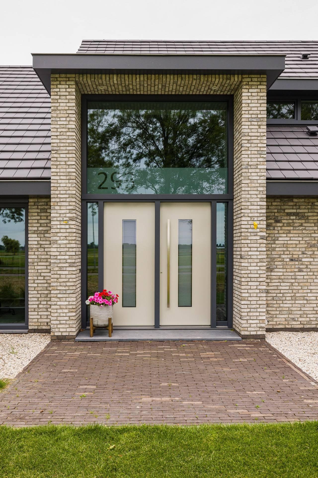 Innovatieve Knipping kozijnen voor renovaties Moderne witte Knipping kunststof deur met glazen panelen in elegante showroomopstelling.